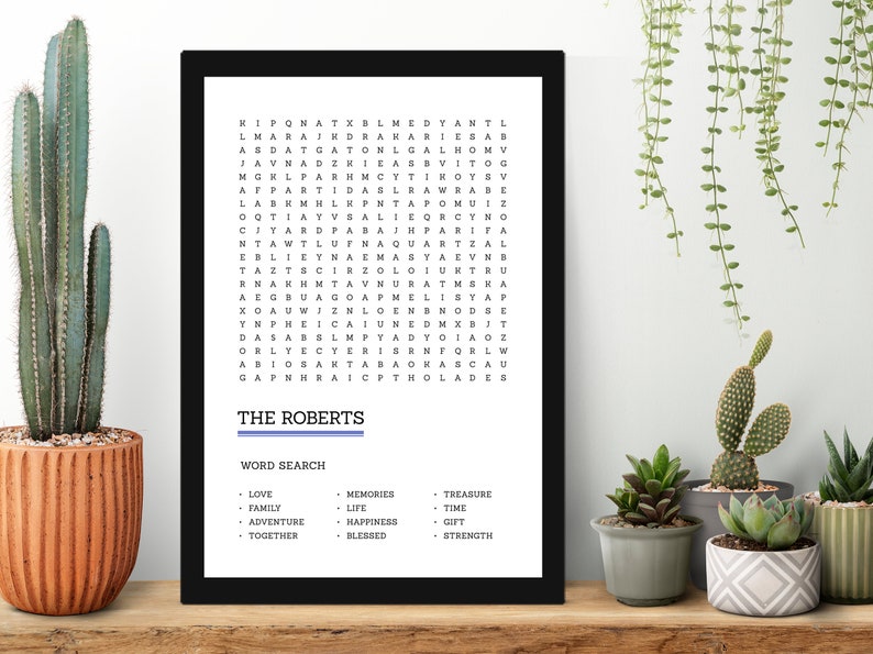 May include: A black framed word search puzzle with the title "The Roberts" and a list of words to find, including love, family, adventure, together, memories, life, happiness, blessed, treasure, time, gift, and strength.