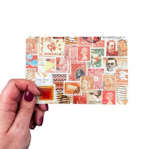 May include: A rectangular collage of vintage postage stamps in shades of red, orange, and brown. The stamps feature various designs, including portraits, floral patterns, and text. Some stamps have text such as "MONCOLIA" and "6 CENTS".