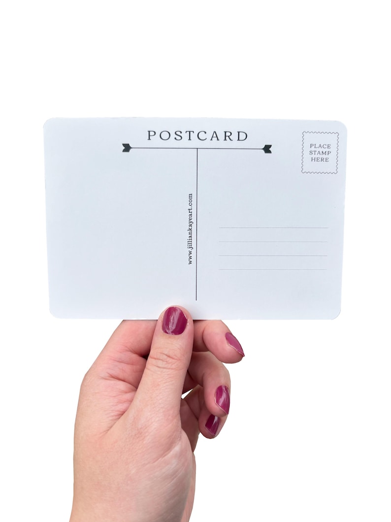 May include: A white postcard with the word "POSTCARD" printed at the top, with lines for writing and a stamp area. The website address "www.jilliankayeart.com" is printed vertically. The postcard is held by a hand with painted nails.