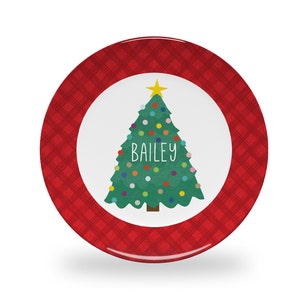 May include: Red and white Christmas plate with a green Christmas tree with colorful ornaments and the name Bailey on it.