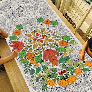 May include: A large coloring page featuring a detailed autumn-themed design with leaves, pumpkins, and acorns. The design is in black and white, ready to be colored in.