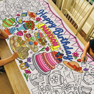 May include: A large white coloring banner with a tea party theme. The banner features a pink and white cake, teacups, teapots, sandwiches, and flowers. The banner also includes the text "Happy Birthday Madison".