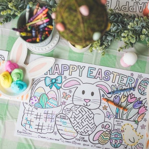 May include: A colorful Happy Easter coloring placemat with a bunny rabbit, eggs, flowers, and a tic-tac-toe game. The placemat also includes a word scramble and a maze.