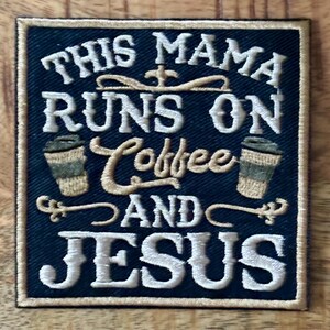 May include: Embroidered patch with the text "THIS MAMA RUNS ON Coffee AND JESUS" in white thread on a navy blue background. The patch features two coffee cup illustrations and decorative flourishes.