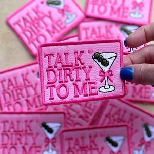 May include: Pink iron-on patches with the text "Talk Dirty To Me" and a martini glass with an olive.