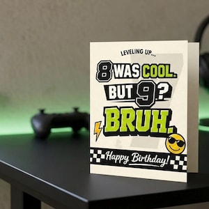 May include: A birthday card with the text "Leveling Up... 8 WAS COOL BUT 9? BRUH. Happy Birthday!" in black, white, and yellow. The card features a smiling face with sunglasses and a lightning bolt graphic.