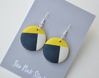 Yellow and navy wooden earrings hand painted in a geometric design