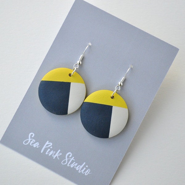 Yellow and navy wooden earrings hand painted in a geometric design