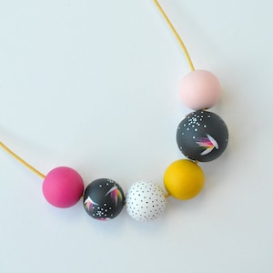 Wooden bead necklace with multi-coloured beads, hand painted in a yellow, pink and charcoal colour palette