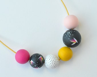 Wooden bead necklace with multi-coloured beads, hand painted in a yellow, pink and charcoal colour palette