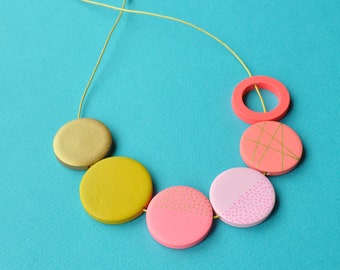 Pink flat bead necklace in minimal design with coastal colours