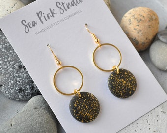 Black and gold wooden earring with elegant gold speckle design