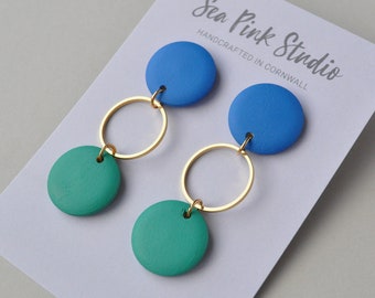 Blue and green wooden painted earrings in modern contemporary style.