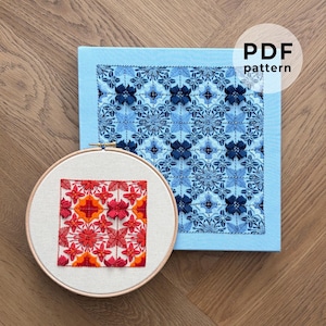 May include: A light blue square with a floral pattern and the text "PDF pattern" is next to a wooden embroidery hoop with a red and orange floral design. The blue square has a darker blue floral pattern.