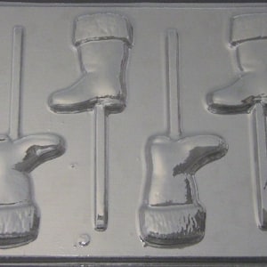 May include: A mold for making chocolate candy in the shape of Santa boots. The mold has five cavities, each with a stick for holding the candy. The mold is made of a white plastic material.