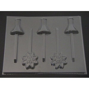 May include: A clear plastic mold for making lollipops. The mold features three lollipop shapes with a flower design and two lollipop shapes with a flask design. The mold is rectangular and has a glossy finish.