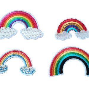 May include: Four embroidered rainbow patches with white clouds. The rainbows are in various sizes and have different colors.