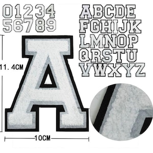 May include: White felt iron-on letters and numbers with black outlines. The letters are in a collegiate font style. The numbers are 1.4 inches tall and the letters are 10 cm tall.