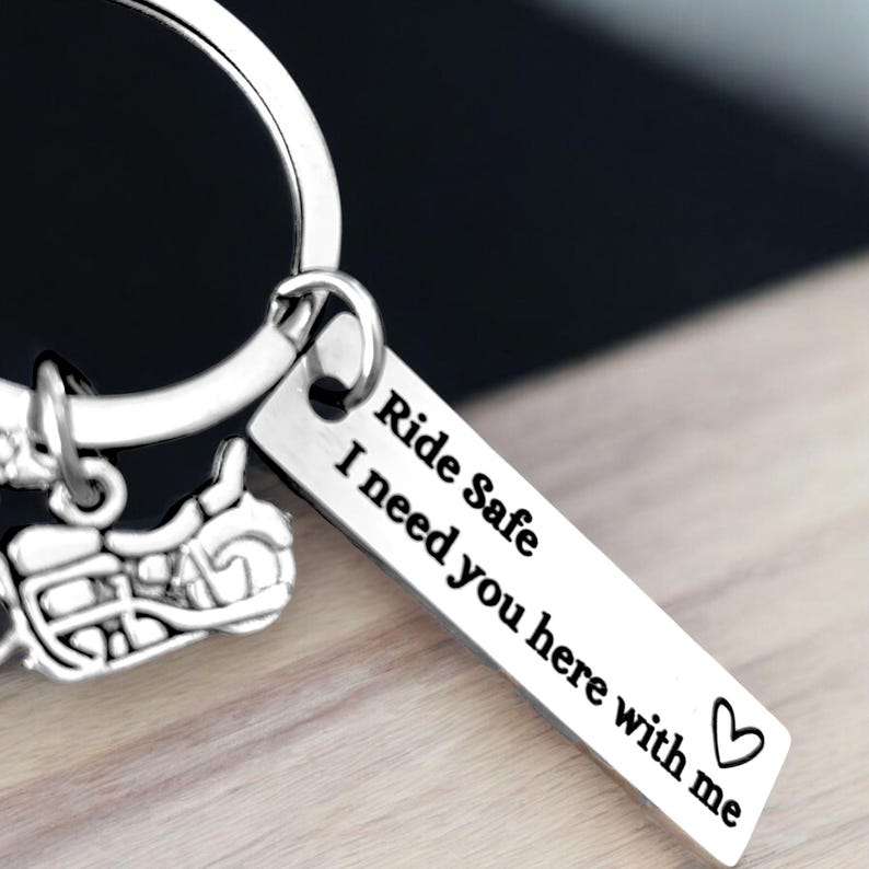 May include: Silver motorcycle keychain with a tag that reads "Ride Safe I need you here with me" and a heart symbol.