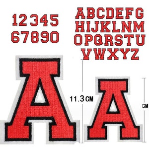 May include: Red iron-on patches of the alphabet, numbers 1-9 and the letter A. The letter A is shown twice, once with a measurement of 11.3 cm.