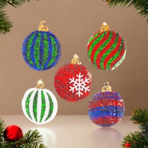 May include: Five Christmas baubles with a variety of sequin patterns. The baubles are red, green, blue, and white with gold accents.