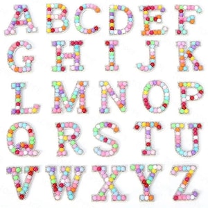 May include: A set of 26 colorful alphabet letters made of beads. Each letter is outlined in white and has a rainbow of colors.