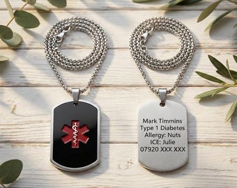 May include: Two silver dog tag necklaces. One tag is black with a red medical symbol. The other tag is silver and has the following text: Mark Timmins, Type 1 Diabetes, Allergy: Nuts, ICE: Julie, 07920 XXX XXX. Both tags hang from a silver chain.