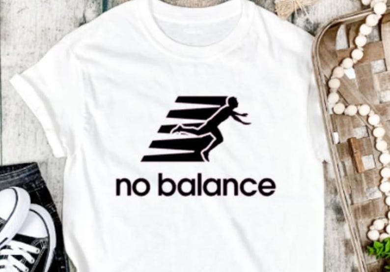 May include: White t-shirt with a black graphic of a person running and the text "no balance".