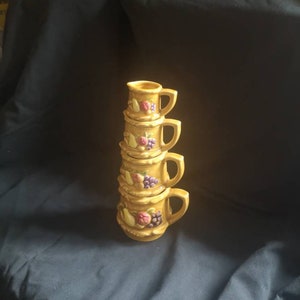 Set of 4 vintage 1960s Stackable Nesting ceramic measuring jugs. Vintage Kitsch Decor. Vintage Kitchen measuring pitchers.