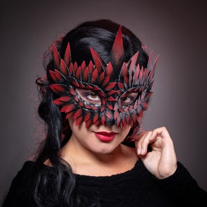 black masquerade mask with red tips