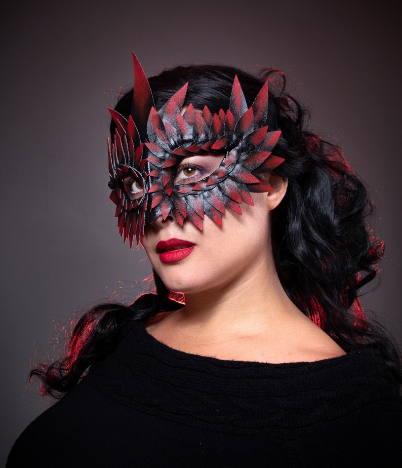 black masquerade mask with red tips