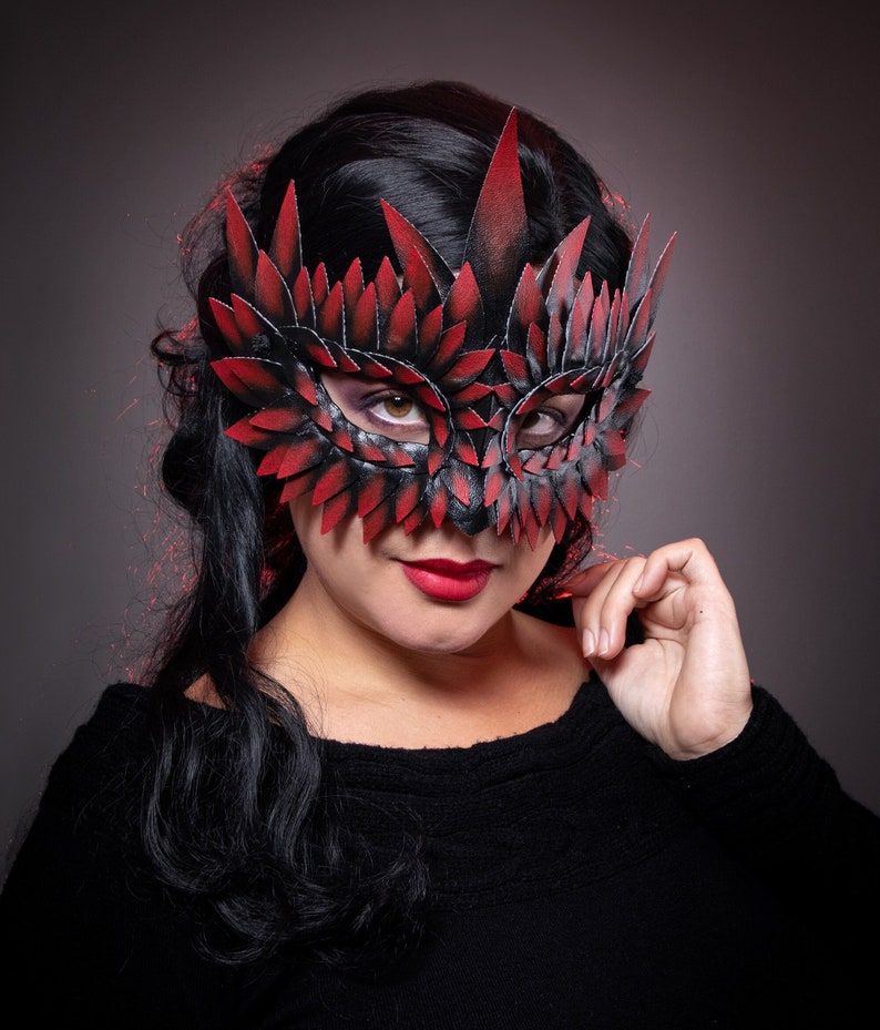black masquerade mask with red tips
