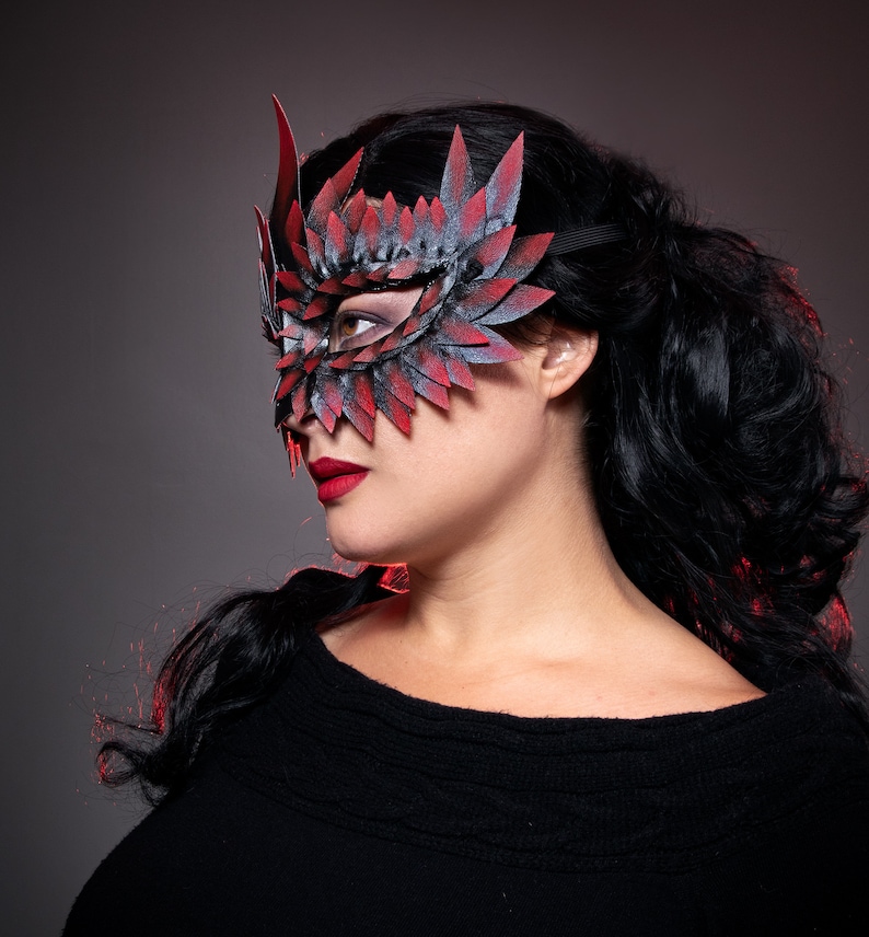 black masquerade mask with red tips