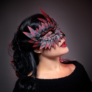 black masquerade mask with red tips