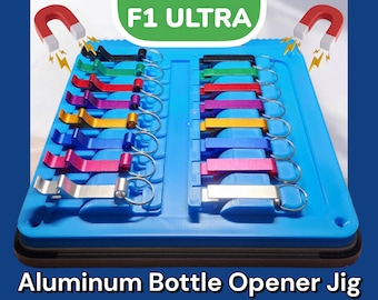 May include: A blue plastic jig with 12 aluminum bottle openers, each with a different color. The jig has the text "F1 ULTRA" in green letters. The jig is designed to hold the bottle openers in place and is magnetic.
