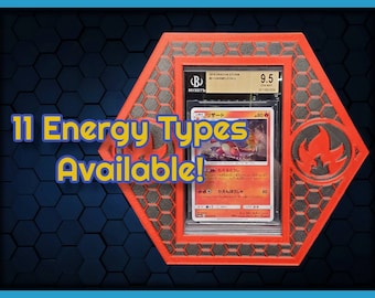 May include: A red and black hexagonal display case with a clear plastic insert holding a Pokemon trading card. The card is a Charmeleon from the Dragon Storm set and is graded 9.5 by Beckett Grading Services. The text on the card reads "リザード" and "80". The case has a red and black flame design on the side. The text "11 Energy Types Available!" is written in yellow on a blue background.