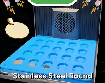 May include: A blue tray with 30 round molds for making stainless steel charms. The tray is labeled "Stainless Steel Round Charms". The tray is inside a machine labeled "F1 ULTRA".