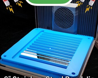 May include: A blue plastic jig with a grid pattern and two holes on the side. The jig is labeled "6" Stainless Steel Band Jig" and is sitting on a white surface. The jig is used to hold a metal band in place while it is being welded.