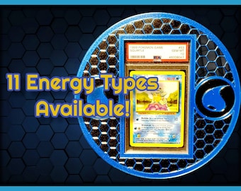 May include: A graded Pokemon card featuring Squirtle from the 1999 Pokemon Game set. The card is in a protective case and has a Gem Mint 10 rating. The text "11 Energy Types Available!" is displayed in yellow letters on a blue background.