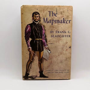 May include: Vintage book cover for "The Mapmaker" by Frank G. Slaughter. The cover features an illustration of a man in historical attire holding a map and dividers. The background is a faded map design with text.