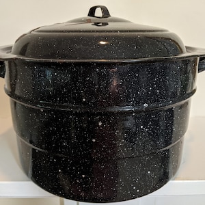 May include: Black enamel canning pot with a white speckled finish and a lid. The pot has two handles on the sides and a single handle on the lid.