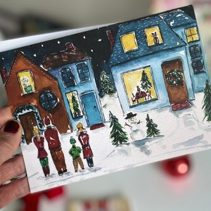 12 kerstkaarten tellen meezingers zingend op gelegd papier met enveloppen