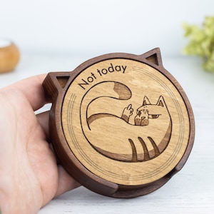 May include: A wooden coaster with a cat design and the text "Not today". The cat is giving the middle finger.