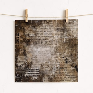 May include: Square print with a vintage newspaper collage design. The artwork features a distressed, aged aesthetic with visible text fragments, in shades of brown, beige, and white. The print is held by wooden pegs on a string.