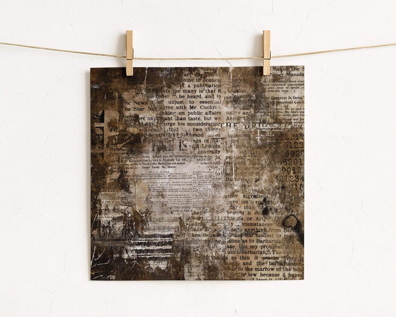 May include: Square print with a vintage newspaper collage design. The artwork features a distressed, aged aesthetic with visible text fragments, in shades of brown, beige, and white. The print is held by wooden pegs on a string.