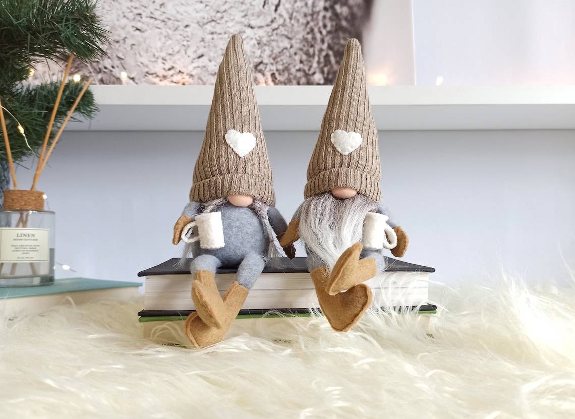 Two gnomes drinking coffee sitting on books