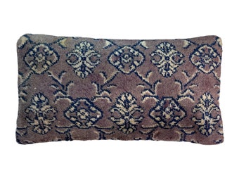 May include: A rectangular pillow with a brown background and a white and blue floral pattern.