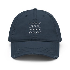 May include: A navy blue distressed baseball cap with a white embroidered design of three different types of waves.