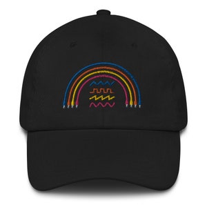 May include: A black baseball cap with an embroidered rainbow design. The rainbow is made of five different colored cords, and there are three wavy lines underneath.