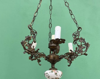 Antique chiseled bronze chandelier with deer heads and women’s faces